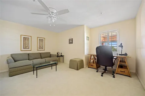 a living room with furniture and a book shelf