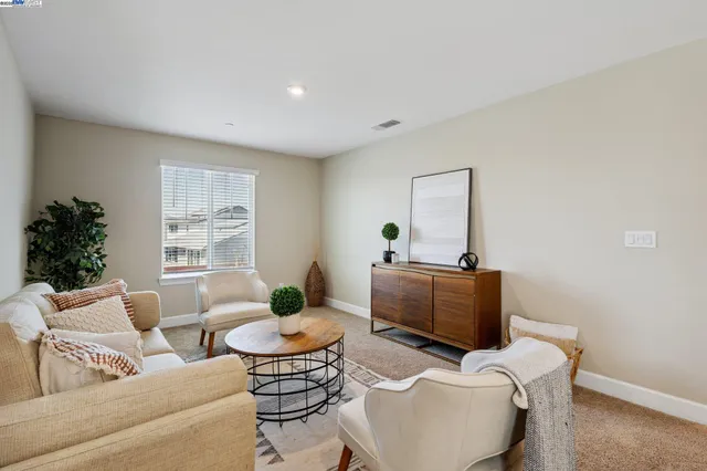 a living room with furniture or couch and a potted plant