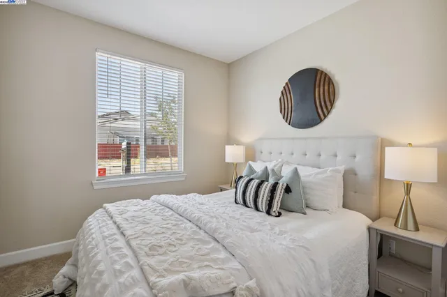 a bedroom with bed and a lamp