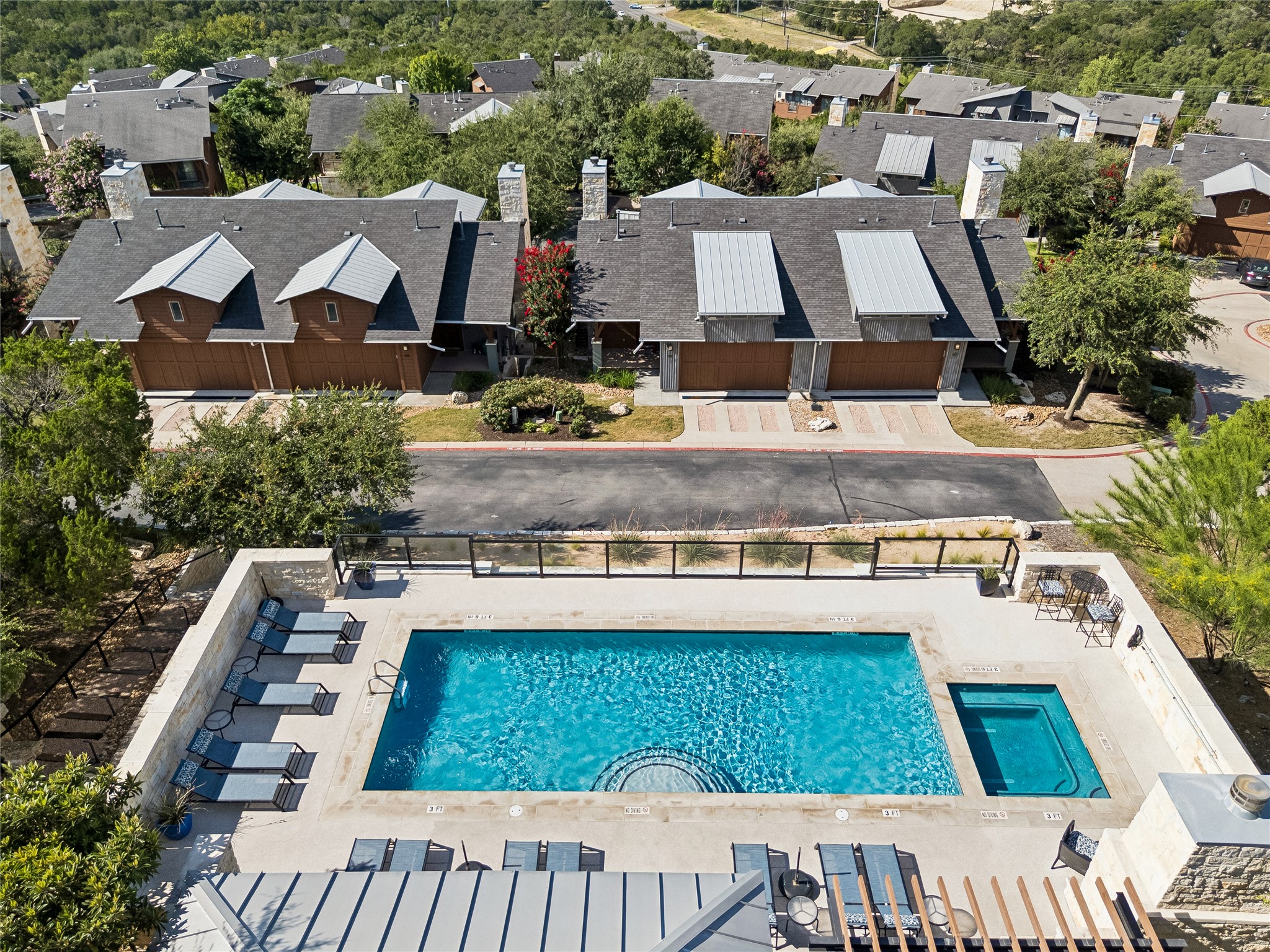 8110 Ranch Road 2222, Unit 68 Austin, TX 78730 - Photo 16 of 24 An aerial perspective reveals a sparkling pool and spa complex, set amidst a vibrant residential community.