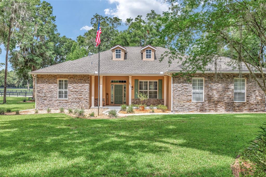 1989 Northwest 111th Loop Ocala, FL 34475 - Photo 2 of 55 a front view of a house with a yard and lake view