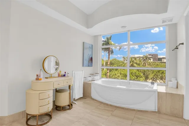 a bathroom with a tub sink and mirror