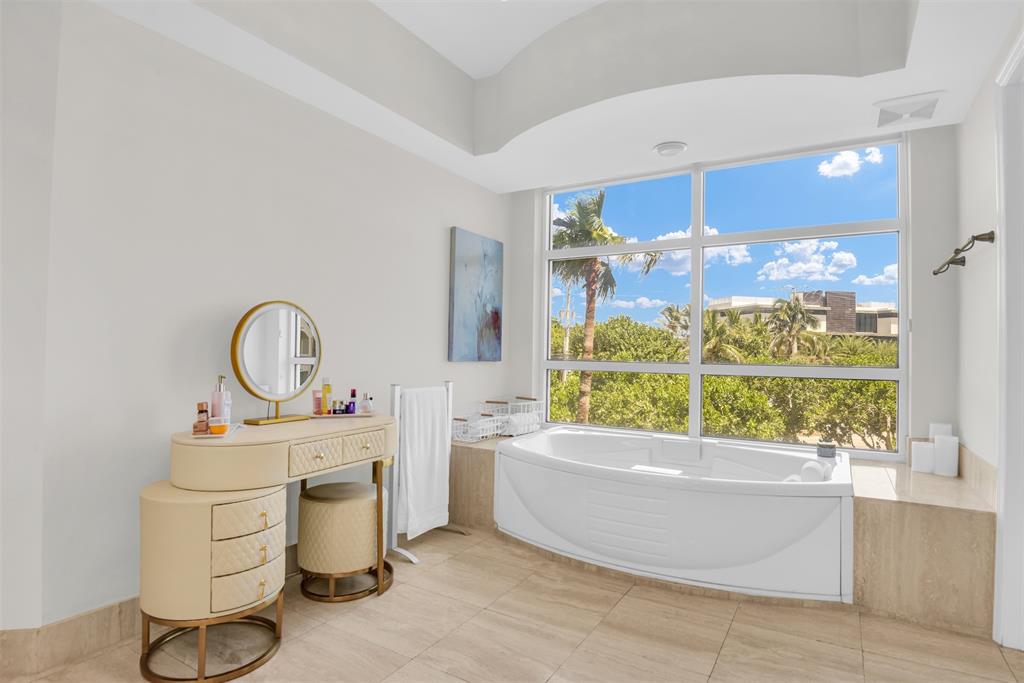 3700 South Ocean Boulevard, Unit 206 Highland Beach, FL 33487 - Photo 15 of 31 a bathroom with a tub sink and mirror