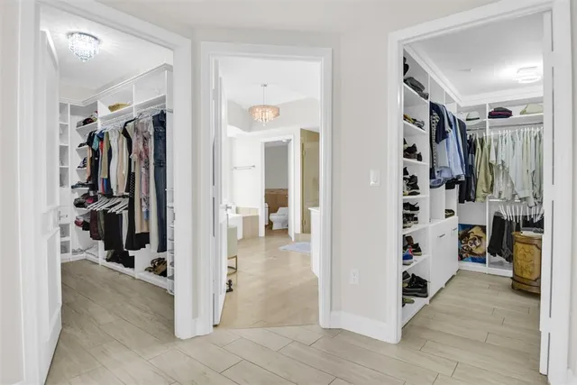 a view of a hallway view with walk in closet
