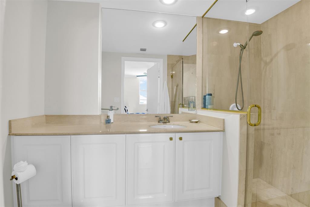 3700 South Ocean Boulevard, Unit 206 Highland Beach, FL 33487 - Photo 19 of 31 a bathroom with a granite countertop sink and a mirror