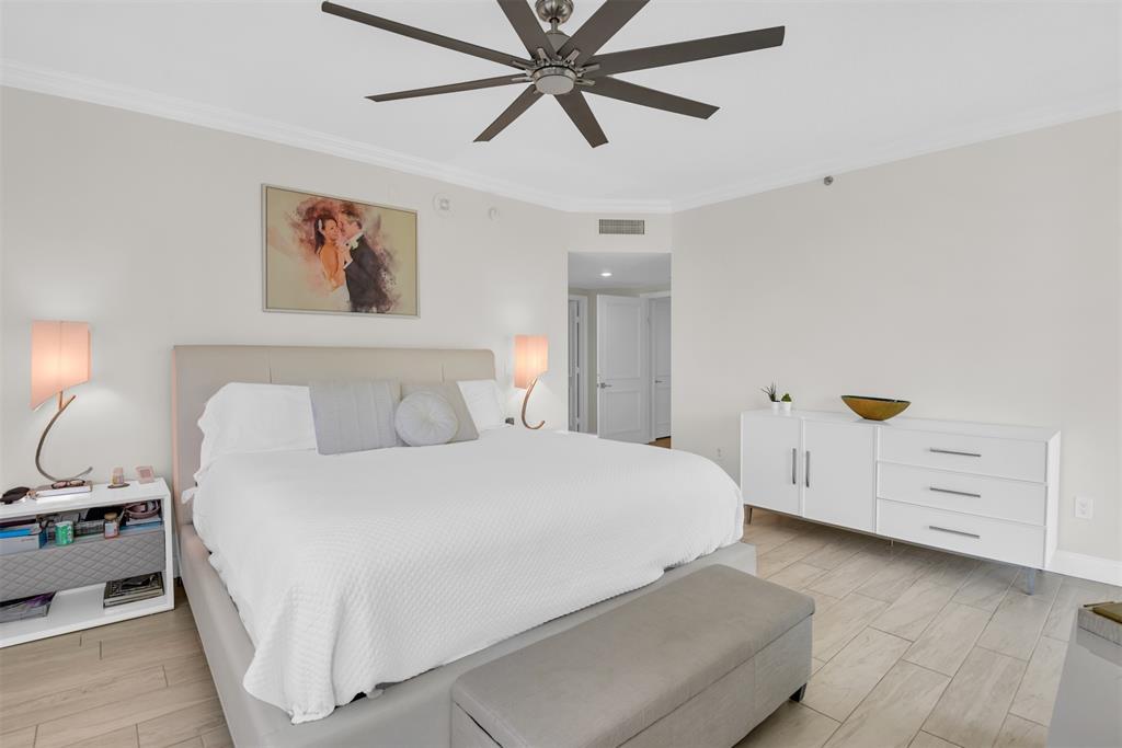 3700 South Ocean Boulevard, Unit 206 Highland Beach, FL 33487 - Photo 23 of 31 a bedroom with a bed and a chandelier