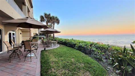 3700 South Ocean Boulevard, Unit 206 Highland Beach, FL 33487 - Photo 30 of 31 a view of a patio with table and chairs under an umbrella