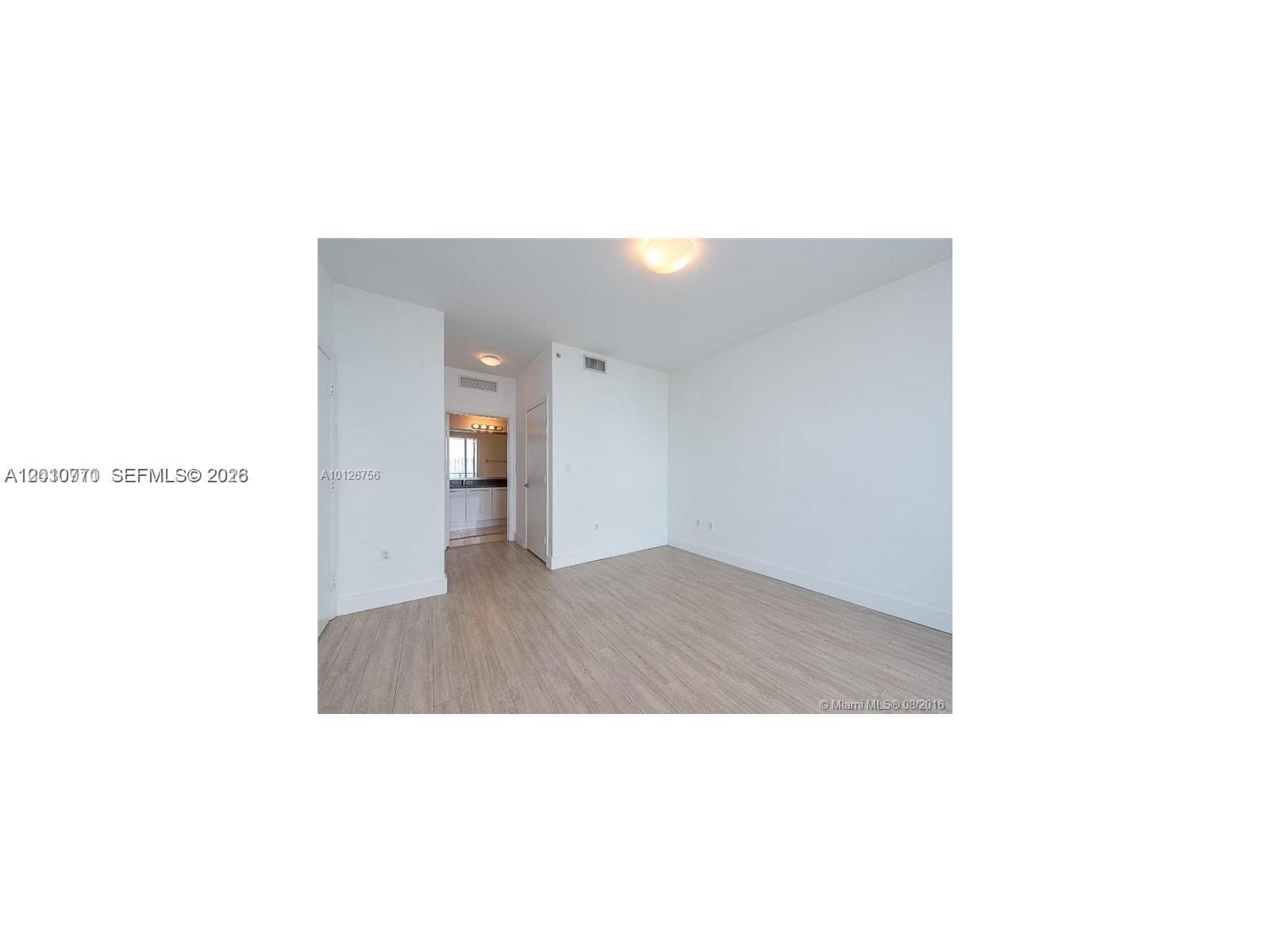 90 Southwest 3rd Street, Unit 2609 Miami, FL 33130 - Photo 7 of 12 a open living room with a hallway and stairs