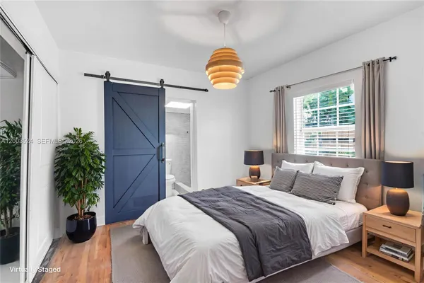 a bedroom with a bed and a potted plant