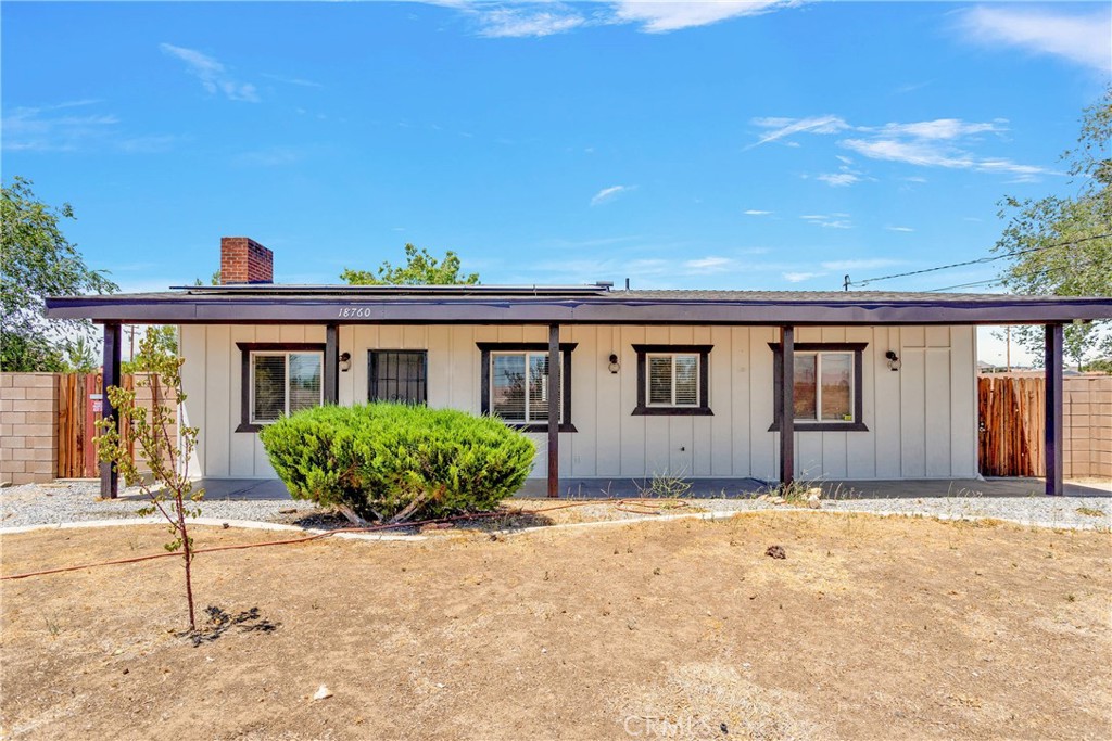 18760 Corwin Road Apple Valley, CA 92307 - Photo 1 of 1 a front view of a house with a garden
