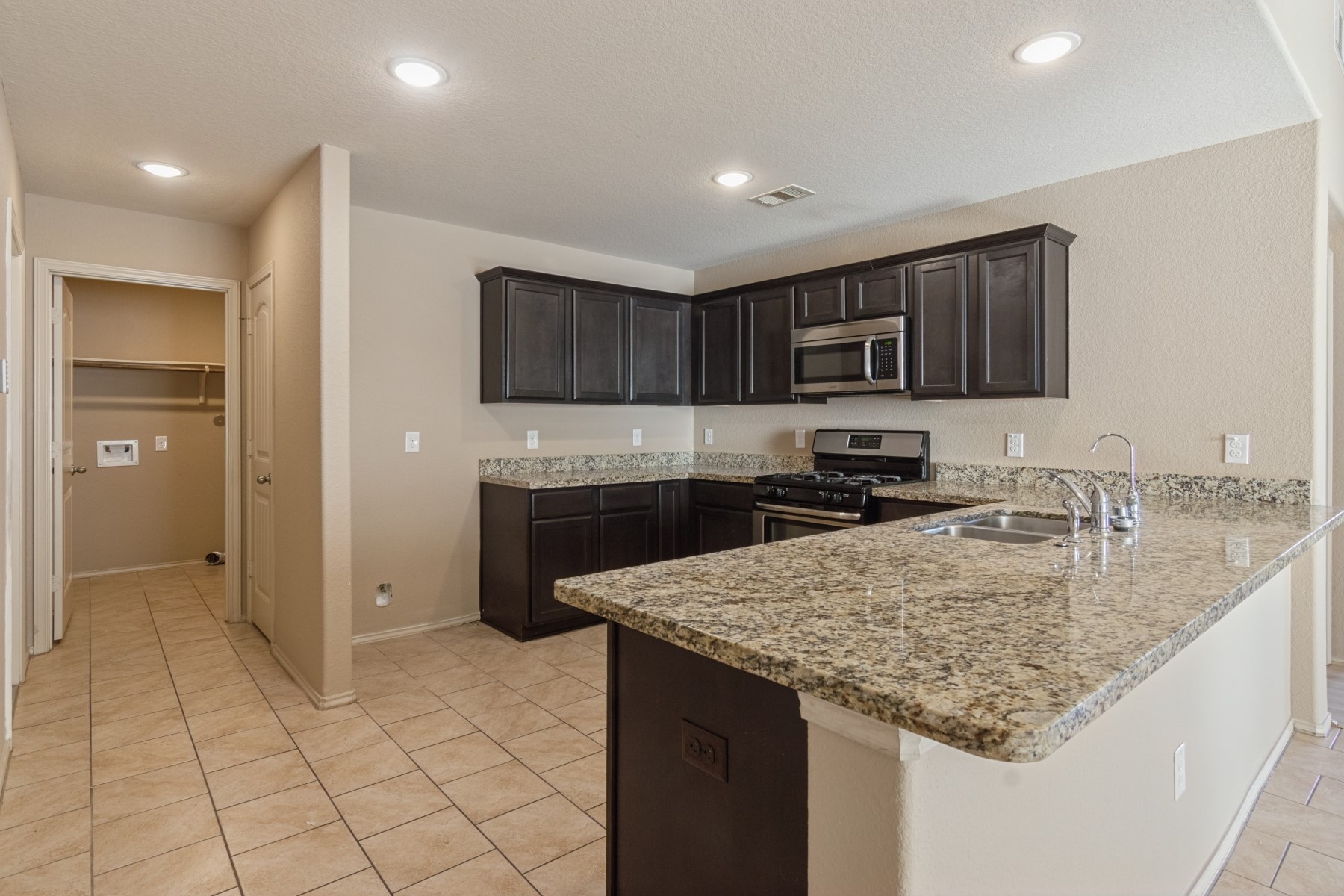 23330 Brat Pass Drive Spring, TX 77373 - Photo 13 of 28 a kitchen with stainless steel appliances granite countertop a sink stove and refrigerator