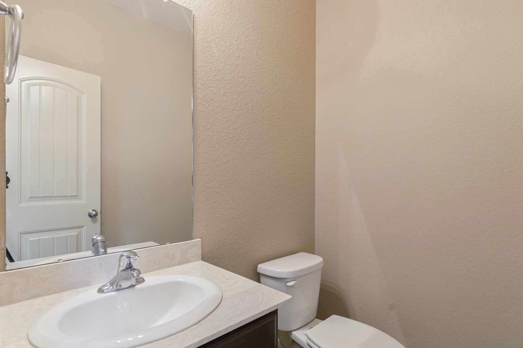 23330 Brat Pass Drive Spring, TX 77373 - Photo 3 of 28 a bathroom with a sink a toilet and a mirror