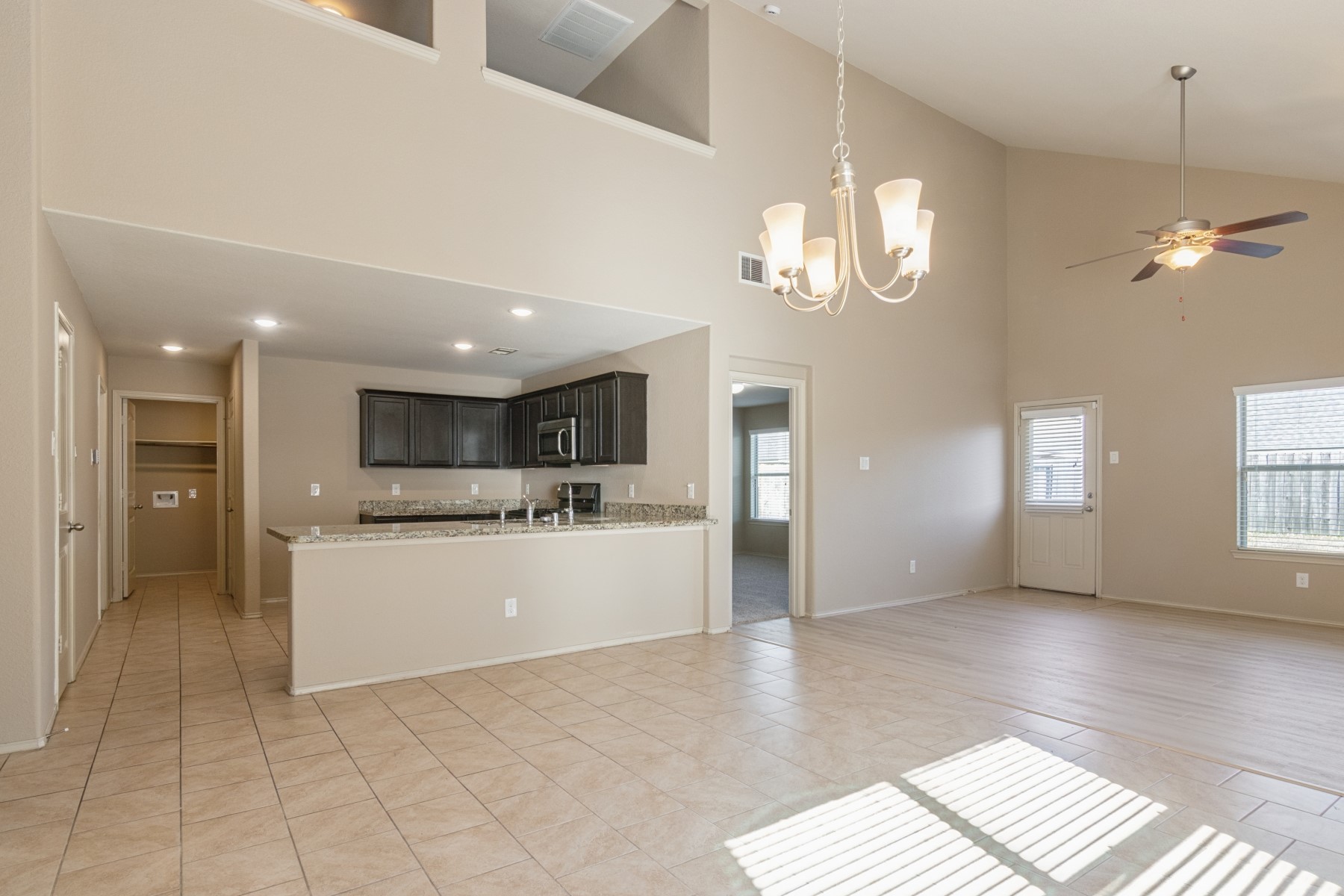 23330 Brat Pass Drive Spring, TX 77373 - Photo 6 of 28 a view of a kitchen with granite countertop natural light wood floor and a window