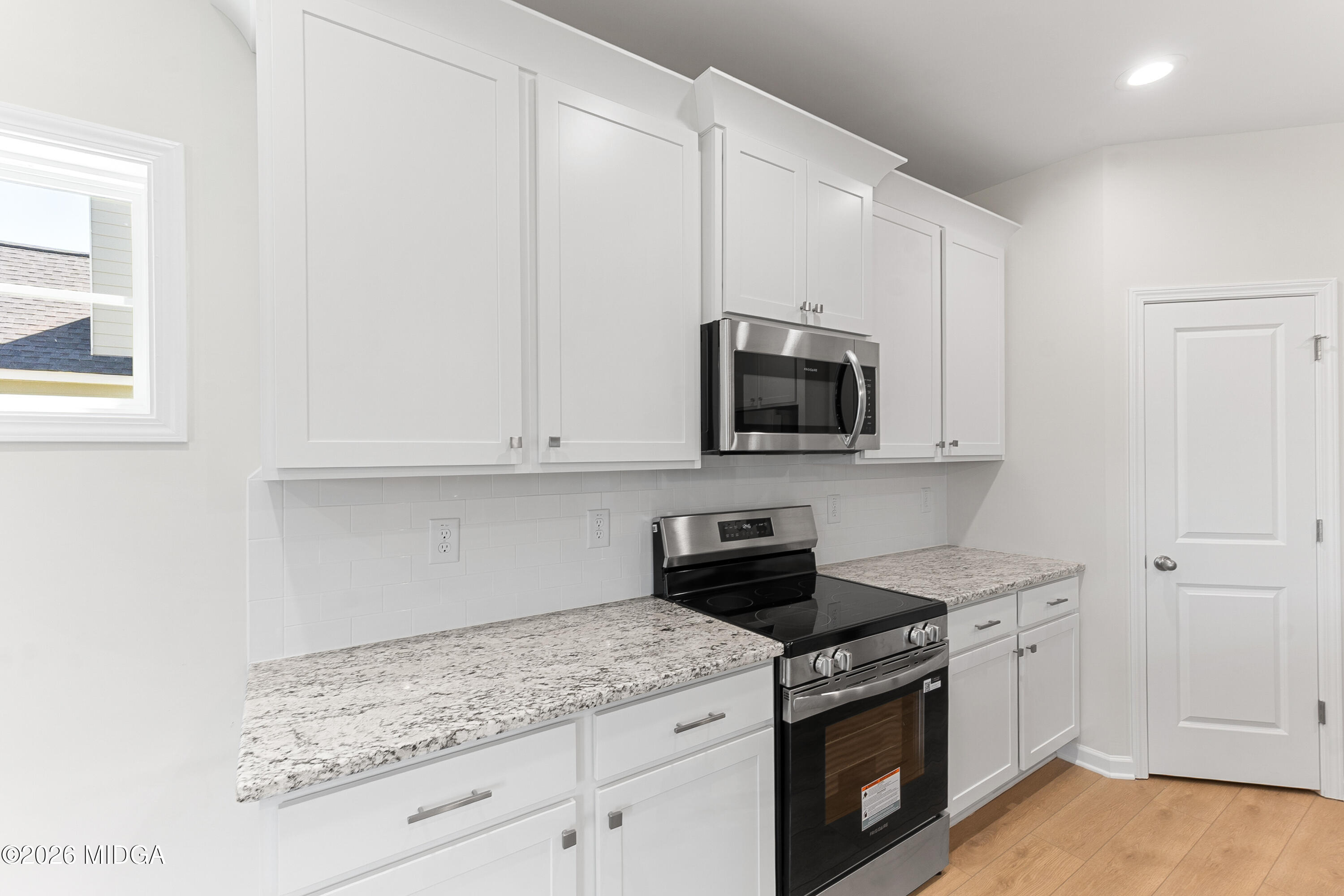 5393 Felles Way, Unit 359 Forsyth, GA 31029 - Photo 20 of 54 a kitchen with stainless steel appliances granite countertop white cabinets and a stove