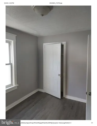 a view of an empty room and wooden floor