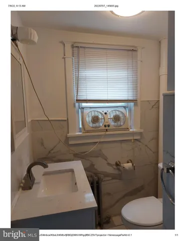 a bathroom with a sink toilet and mirror