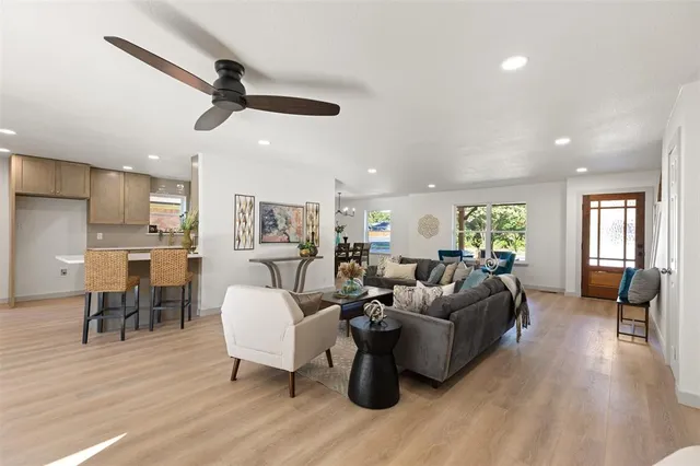 a living room with furniture and a wooden floor