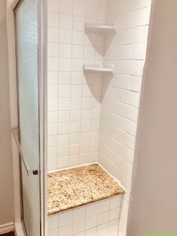 a white toilet sitting next to a white wall