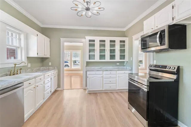 a kitchen with stainless steel appliances a stove microwave and cabinets