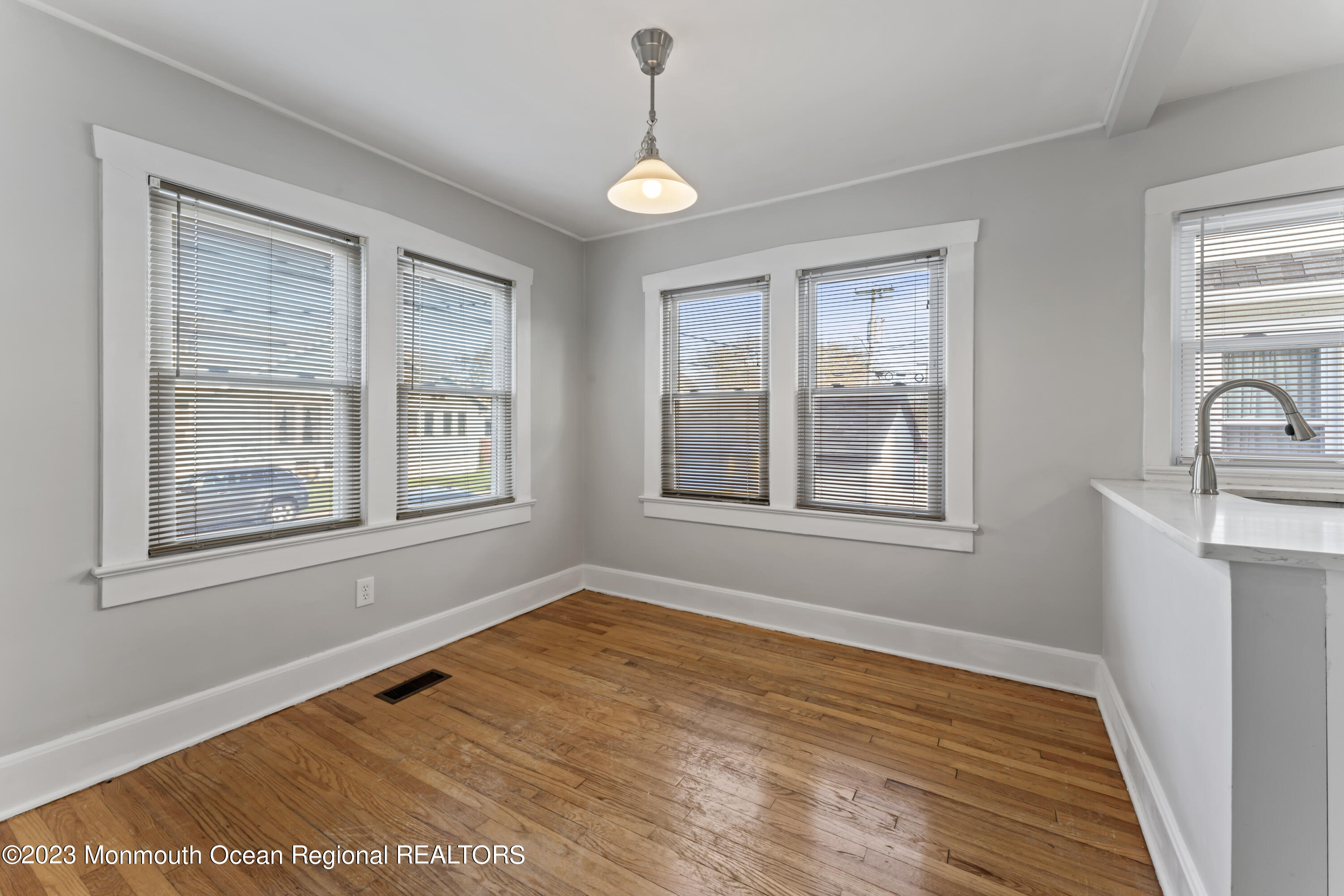 1302 B Street Belmar, NJ 07719 - Photo 12 of 42 a view of an empty room with window and wooden floor