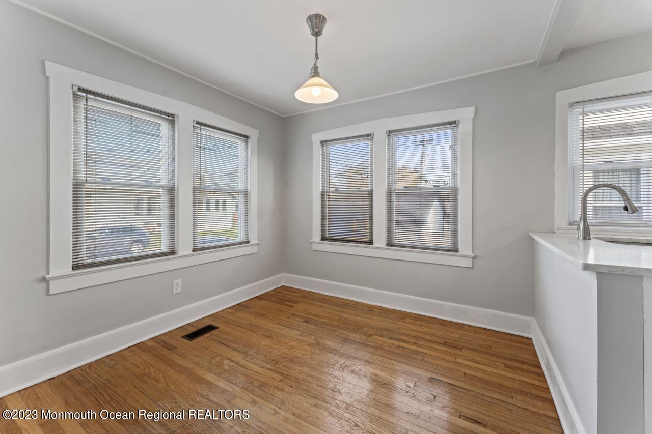1302 B Street Belmar, NJ 07719 - Photo 32 of 42 a view of an empty room with a window and wooden floor