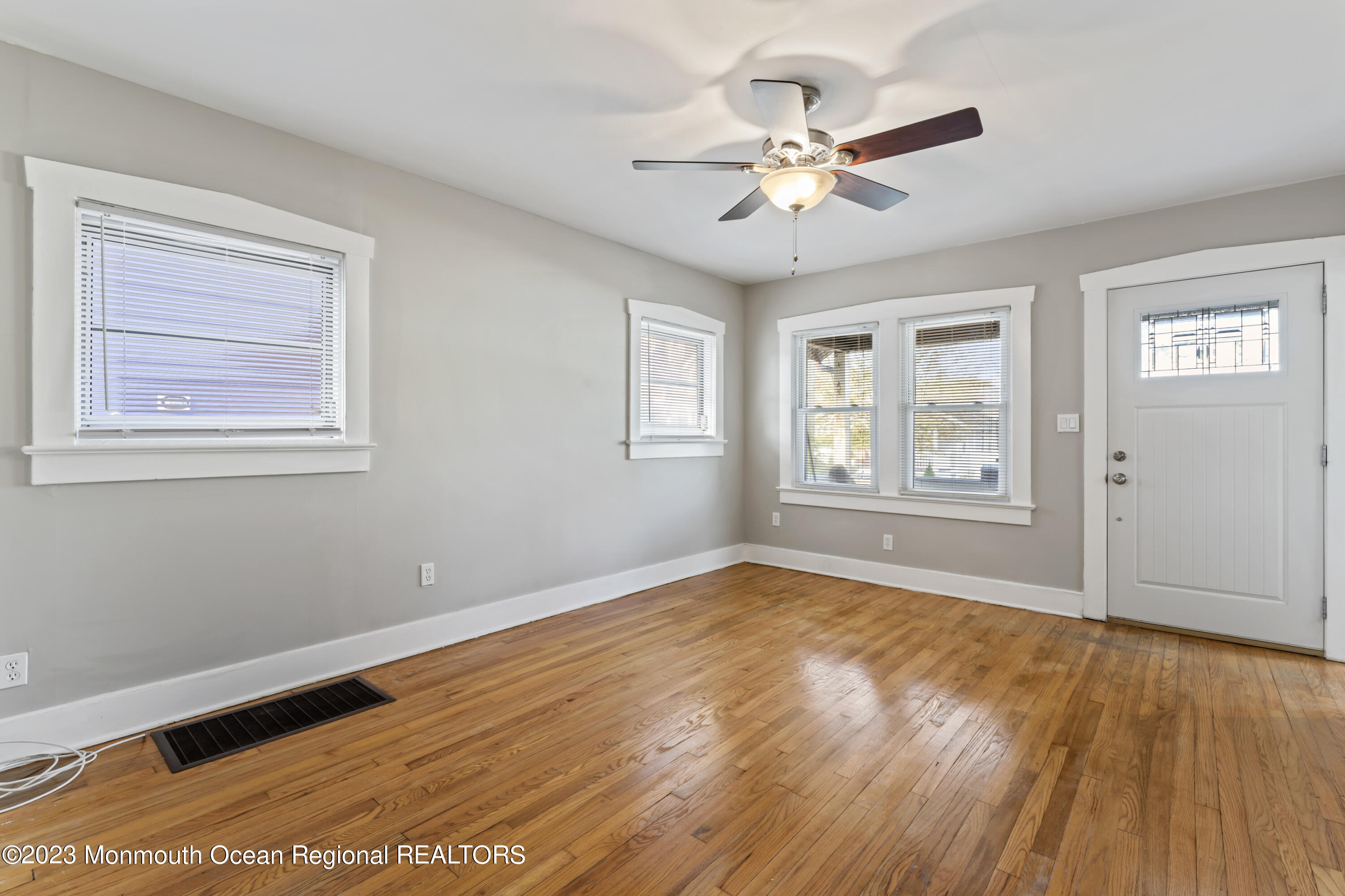 1302 B Street Belmar, NJ 07719 - Photo 4 of 42 a view of an empty room with wooden floor and a window
