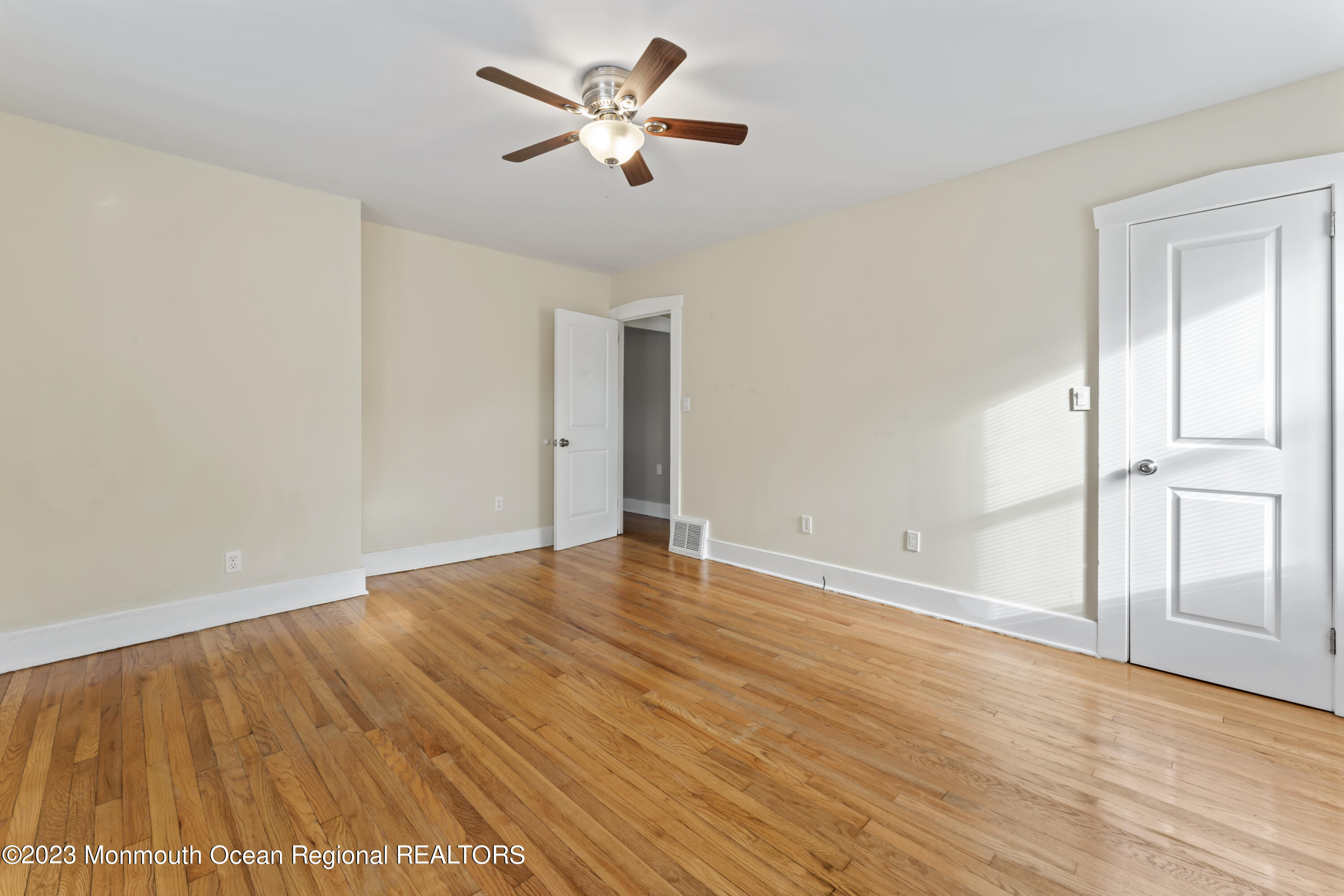 1302 B Street Belmar, NJ 07719 - Photo 8 of 42 wooden floor in an empty room with a window