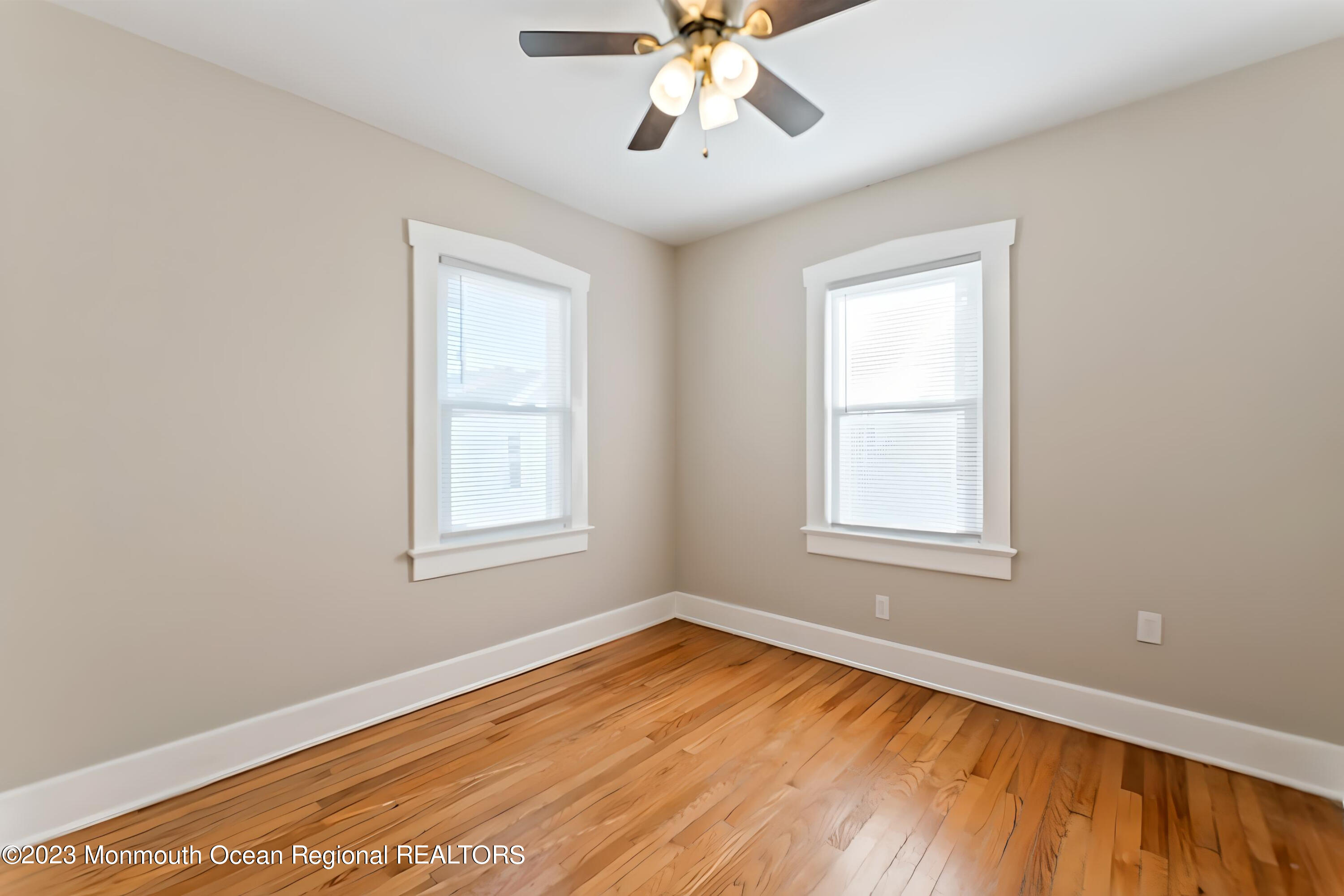 1302 B Street Belmar, NJ 07719 - Photo 9 of 42 a view of an empty room with wooden floor and a window
