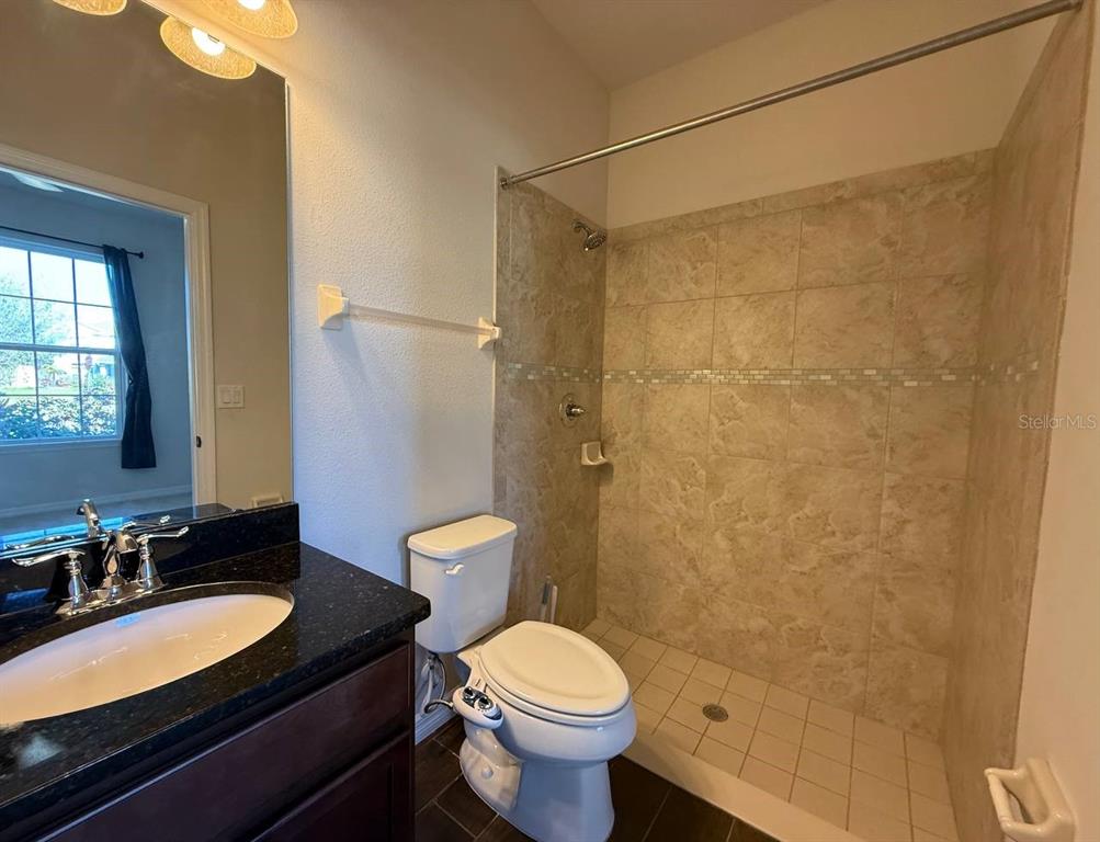 14112 Poke Ridge Drive Riverview, FL 33579 - Photo 14 of 32 a bathroom with a granite countertop sink toilet and shower