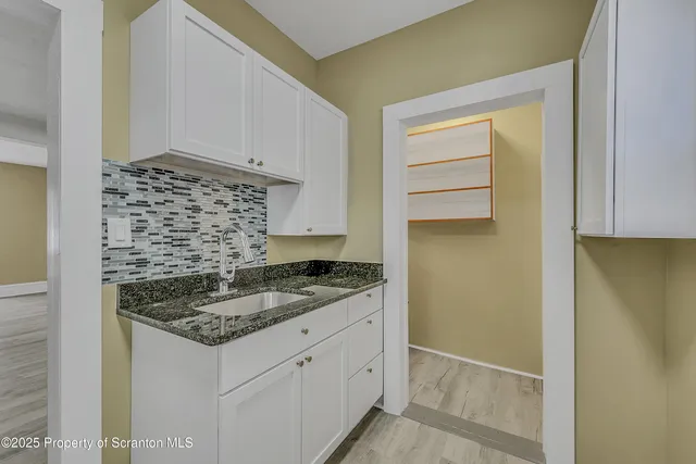 a kitchen with a granite countertop cabinets and a sink