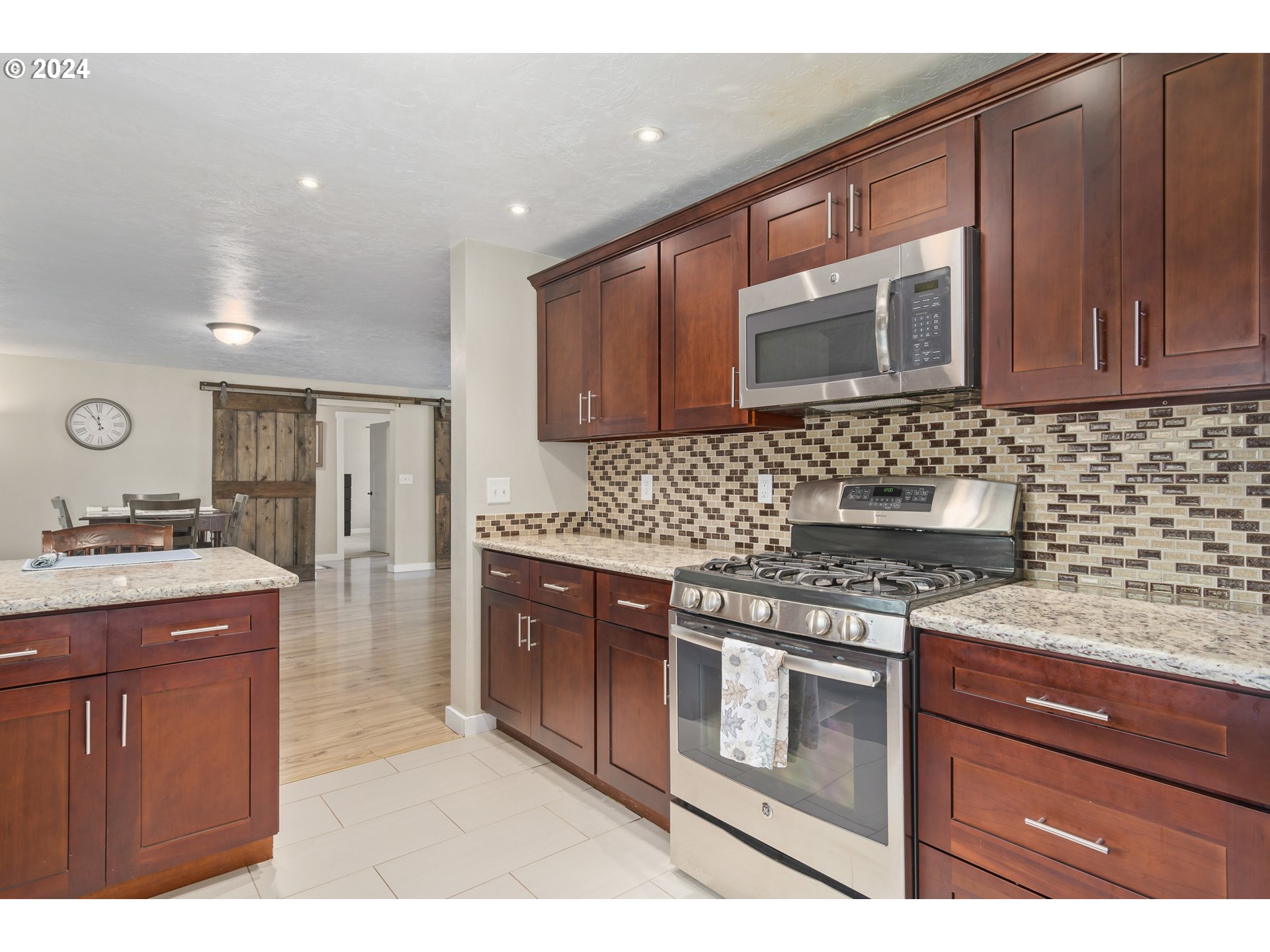 273 West Anchor Avenue Eugene, OR 97404 - Photo 14 of 43 a kitchen with stainless steel appliances granite countertop a stove a sink and a microwave