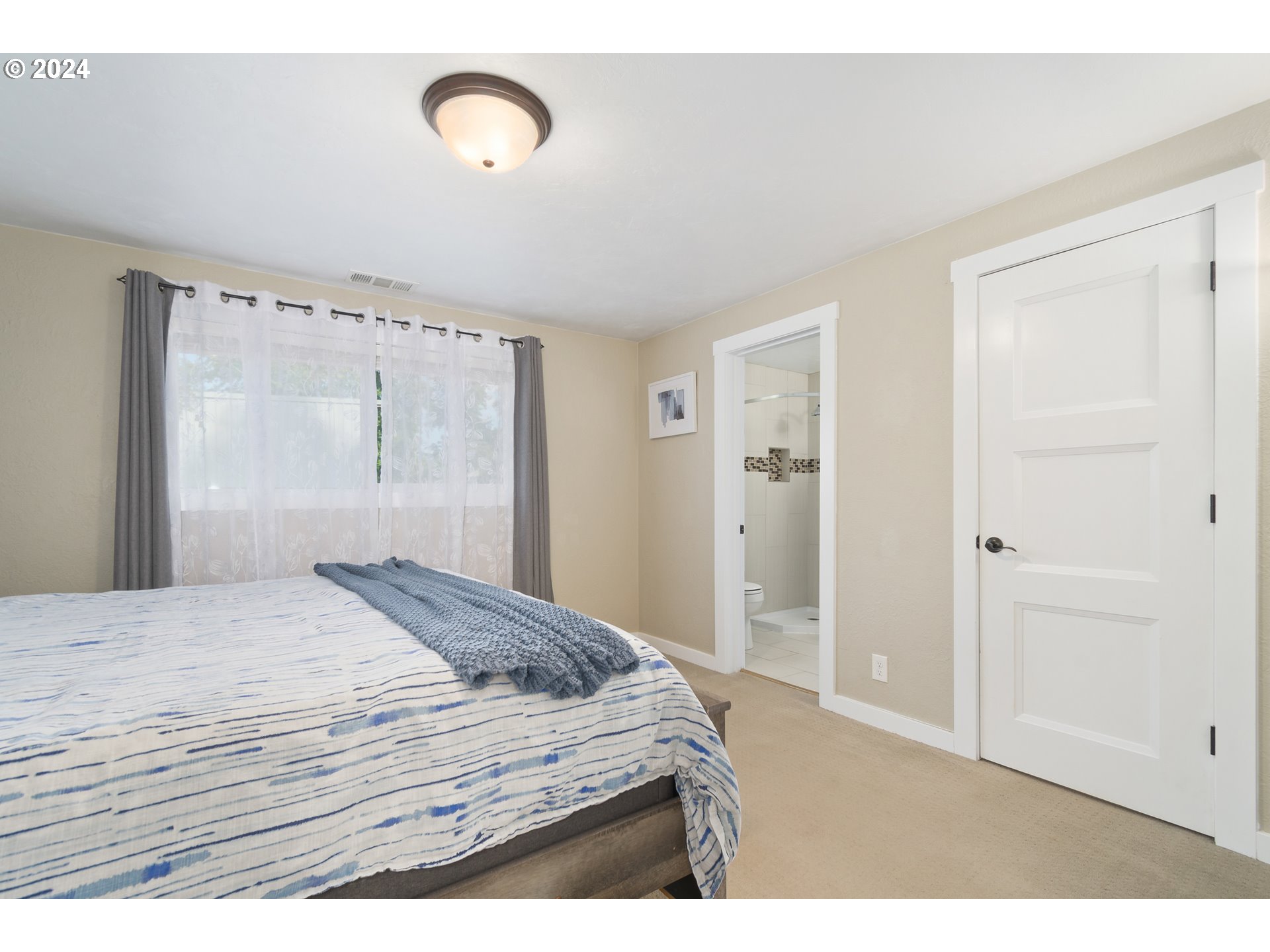 273 West Anchor Avenue Eugene, OR 97404 - Photo 24 of 43 a bedroom with a bed and a mirror
