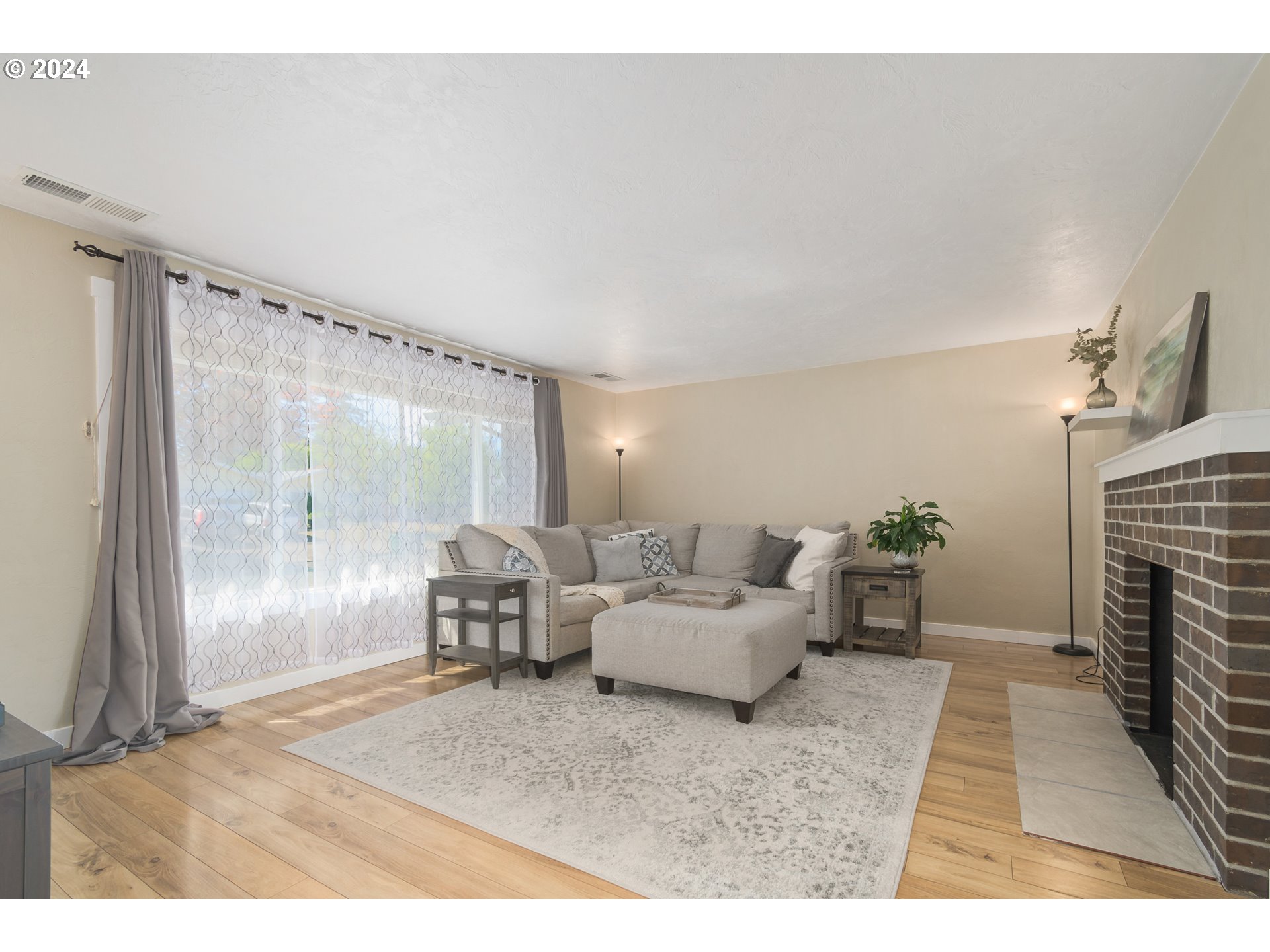 273 West Anchor Avenue Eugene, OR 97404 - Photo 6 of 43 a living room with furniture and a fireplace