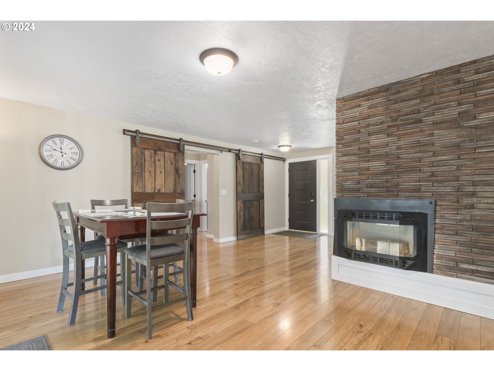 273 West Anchor Avenue Eugene, OR 97404 - Photo 9 of 43 a view of a dining room and kitchen with furniture and a fireplace