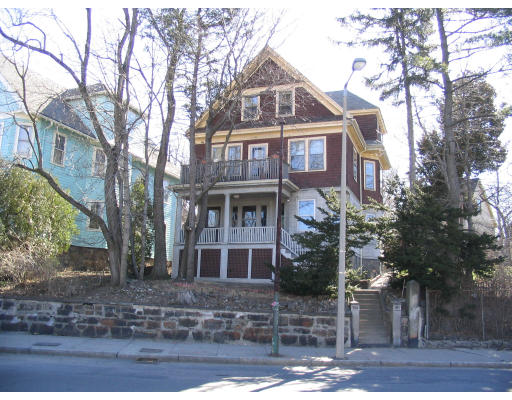 a front view of a residential apartment building with a yard
