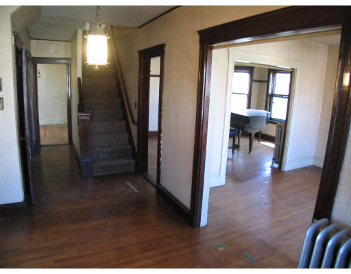 584 Centre Street Boston, MA 02130 - Photo 11 of 26 a view of a hallway with wooden floor and furniture