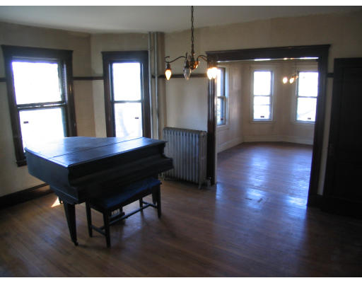 584 Centre Street Boston, MA 02130 - Photo 15 of 26 a view of a room with wooden floor and windows