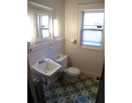 584 Centre Street Boston, MA 02130 - Photo 17 of 26 a bathroom with a toilet sink and mirror