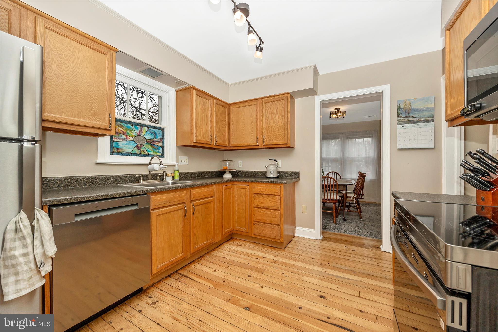 633 Lee Place Frederick, MD 21702 - Photo 12 of 48 a kitchen with stainless steel appliances granite countertop a refrigerator a sink dishwasher a stove and white countertops with wooden floor