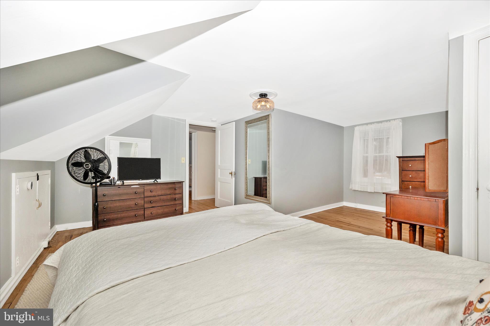 633 Lee Place Frederick, MD 21702 - Photo 21 of 48 a bedroom with a bed and a chair with the view of kitchen