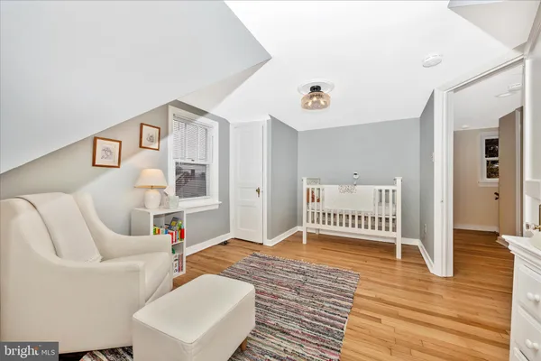 a bedroom with furniture and a wooden floor