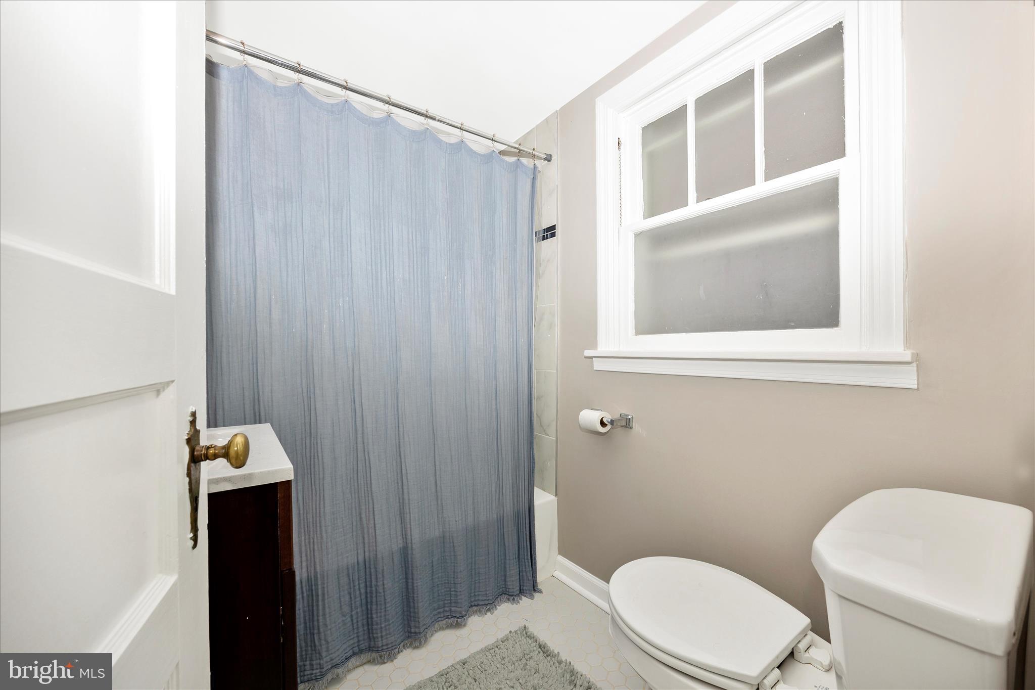 633 Lee Place Frederick, MD 21702 - Photo 28 of 48 a bathroom with a toilet and a shower curtain