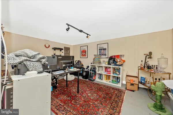 a living room with furniture and a book shelf