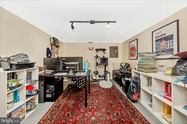 a living room with lots of furniture and clutter
