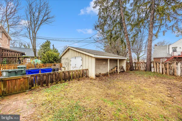 a view of a house with a wooden fence