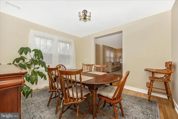 a view of a dining room with furniture and a potted plant