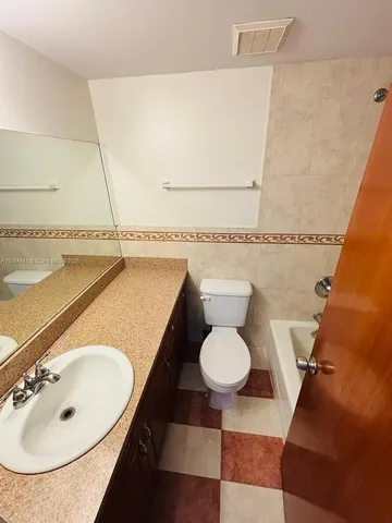 a view of a refrigerator and window in a room