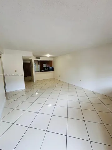 an empty room with a fireplace and cabinet