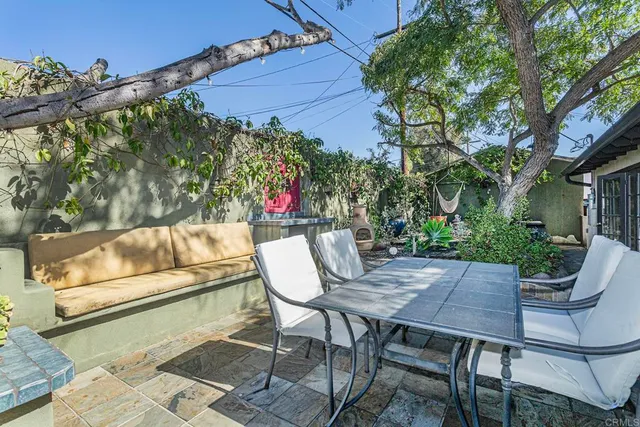 a view of patio with table and chairs and potted plants