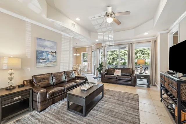 a living room with furniture a large window and a flat screen tv